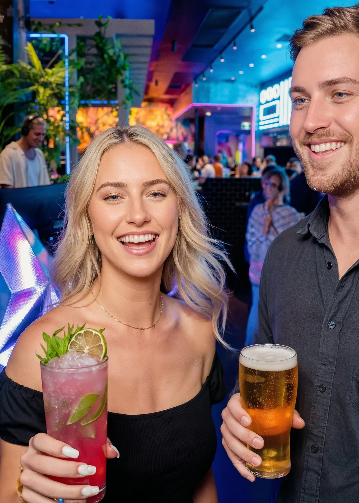Two guests smiling with a cocktail and a beer on a Saturday night at Milky Lane