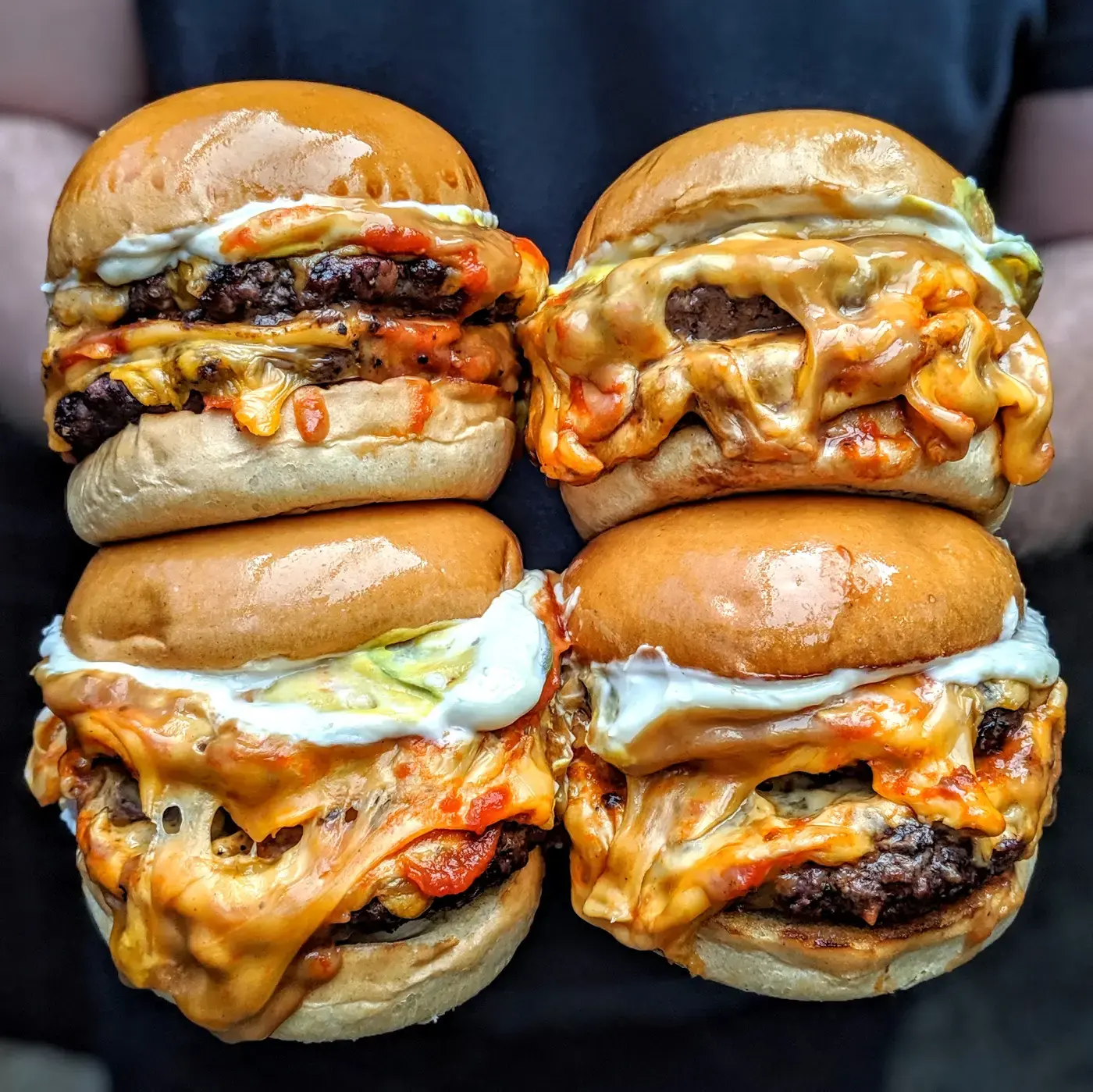 Four Milky Lane smashed burgers with a cheese pull