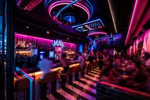 The high bar at Milky Lane Canberra in pink and blue neon