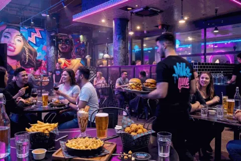 The dining room at Milky Lane Curtin Exchange, mural wall and full tables