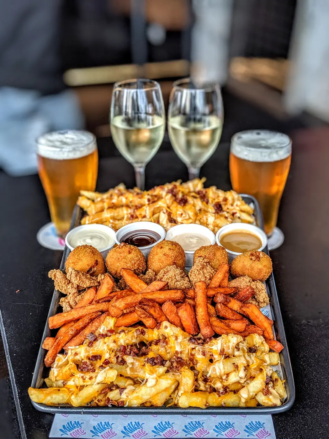 Milky Lane share platter · loaded fries, sweet potato fries, mash balls, popkorn chicken with beers and wines